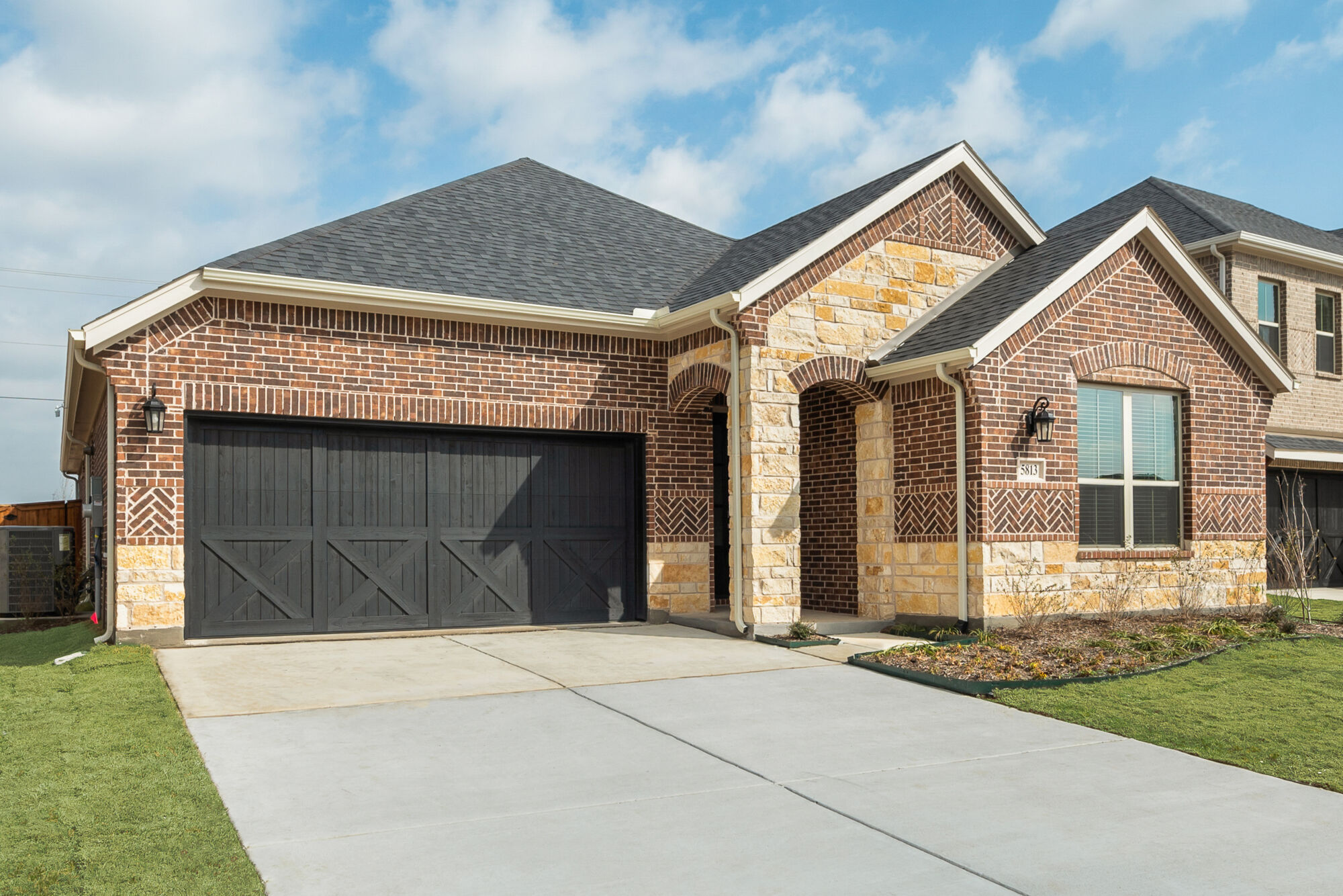 Elevation Front with garage, window, exterior brick and exterior stone