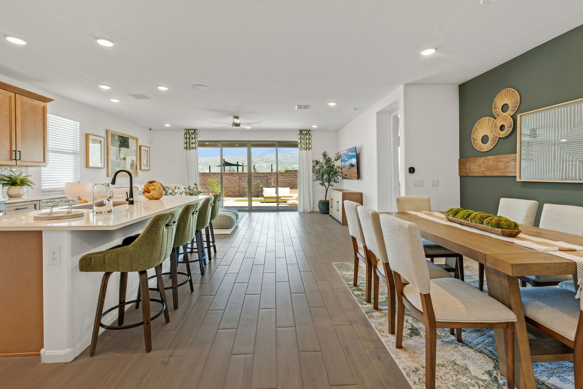Greatroom with dining table and chairs, barstools, wall art