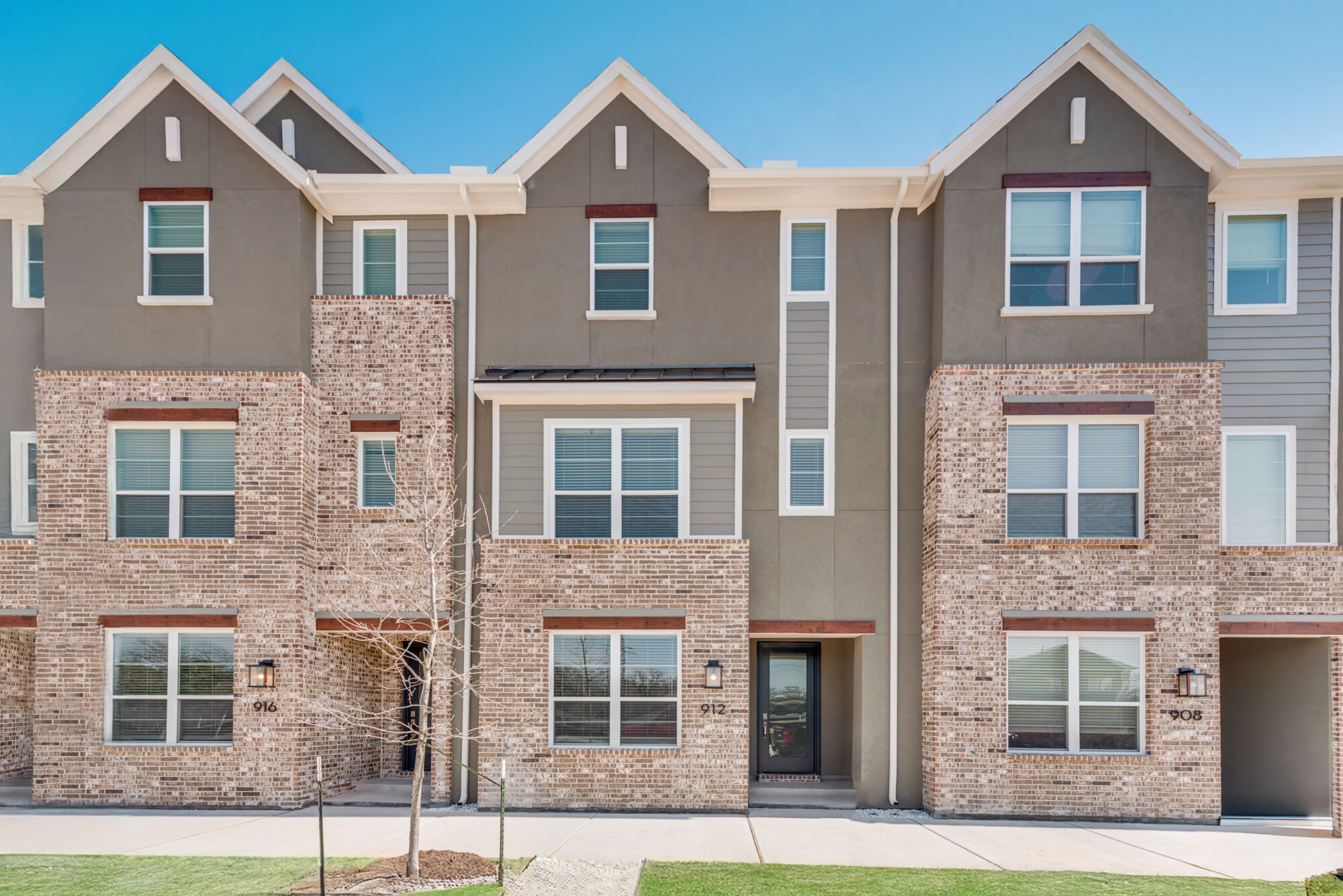 Town Homes with window, door, exterior brick and exterior clapboard