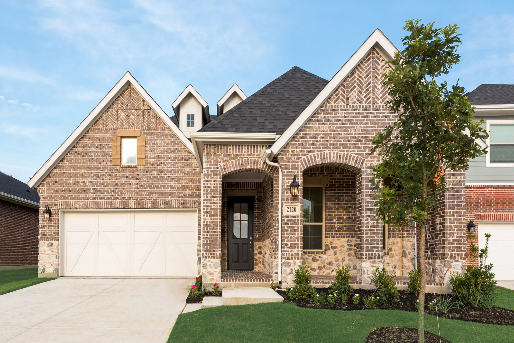 Elevation Front with garage, window, door, exterior stone and exterior brick