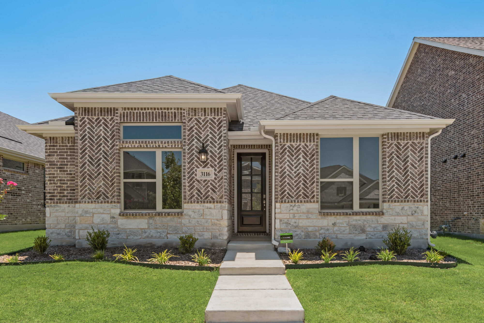 Elevation Front with window, door, exterior stone and exterior brick