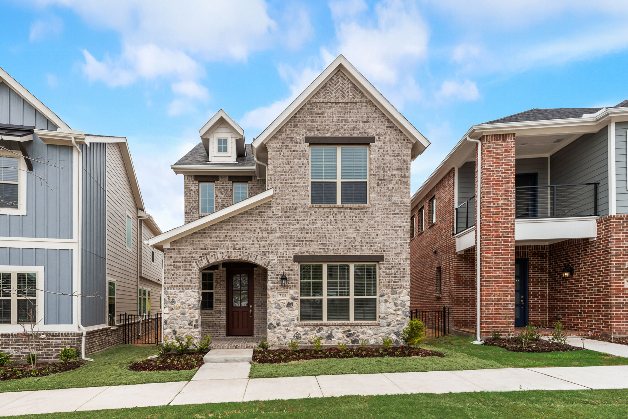 Elevation Front with window, door, exterior stone and exterior brick