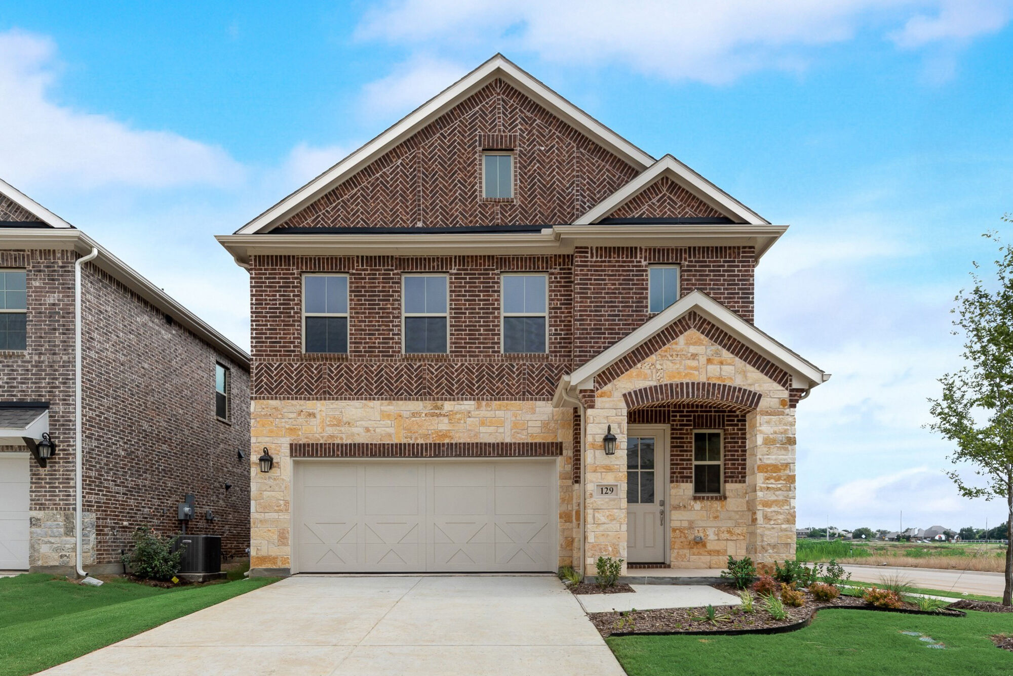 Elevation Front with garage, window, door, exterior brick and exterior stone
