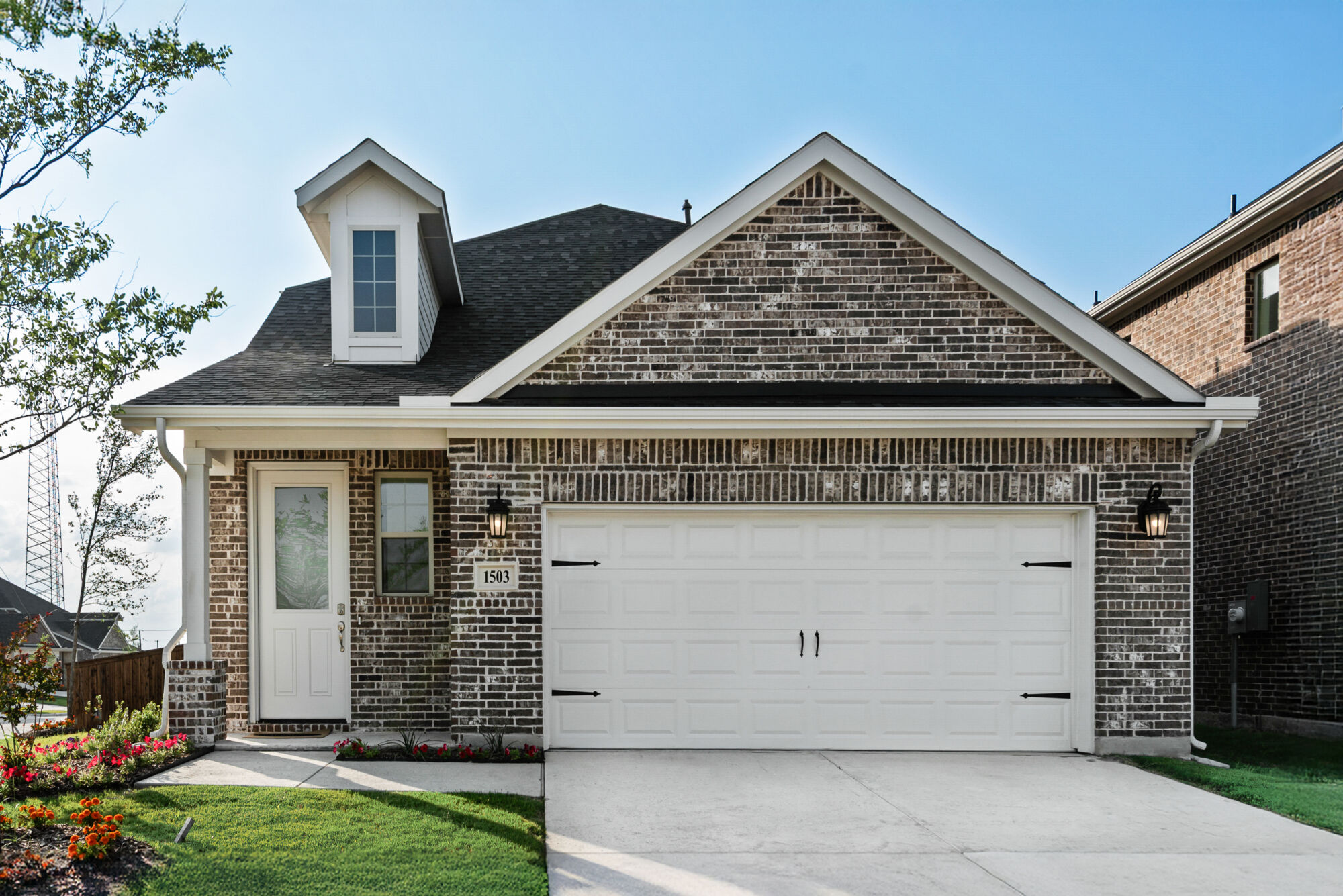 Elevation Front with garage, window, door and exterior brick