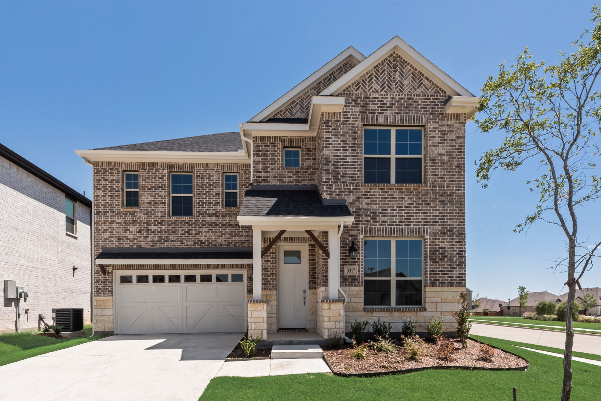 Elevation Front with window, garage, door, exterior brick and exterior stone