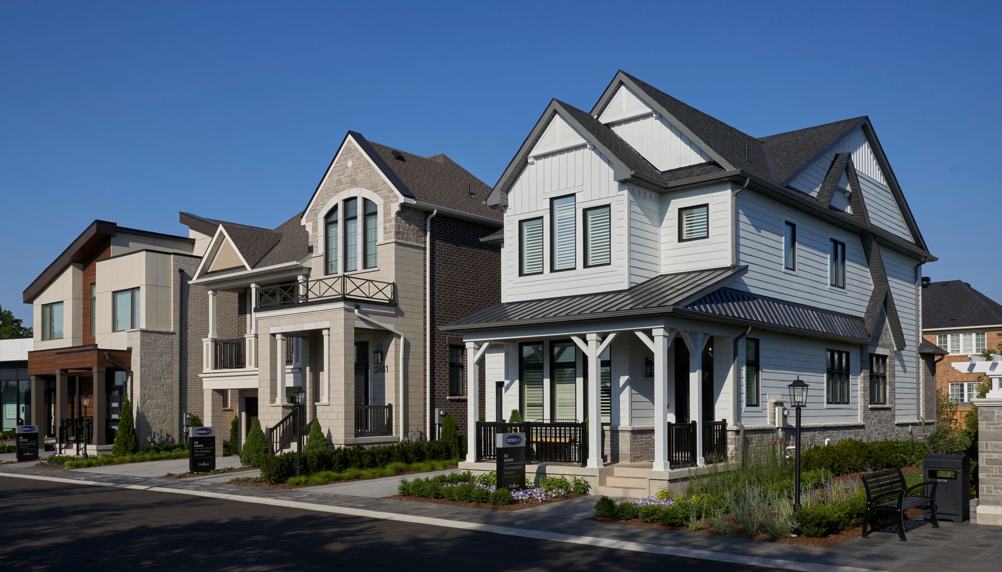 A streetscape of three Mattamy model homes featuring different elevations