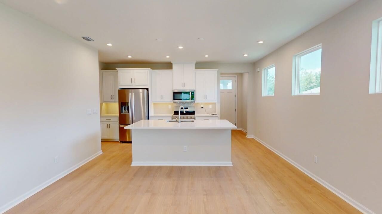 Single-Wall Kitchen with window, refrigerator, white cabinets, door, wood flooring and raised panel cabinets