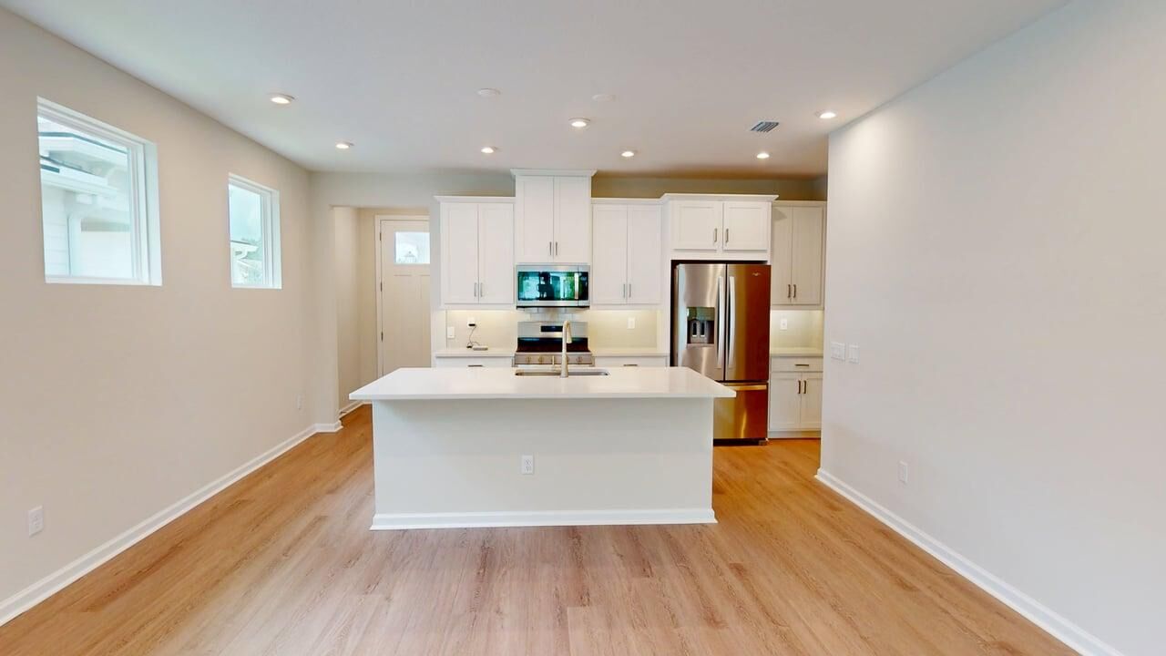 Single-Wall Kitchen with window, refrigerator, white cabinets, wood flooring, door and oven