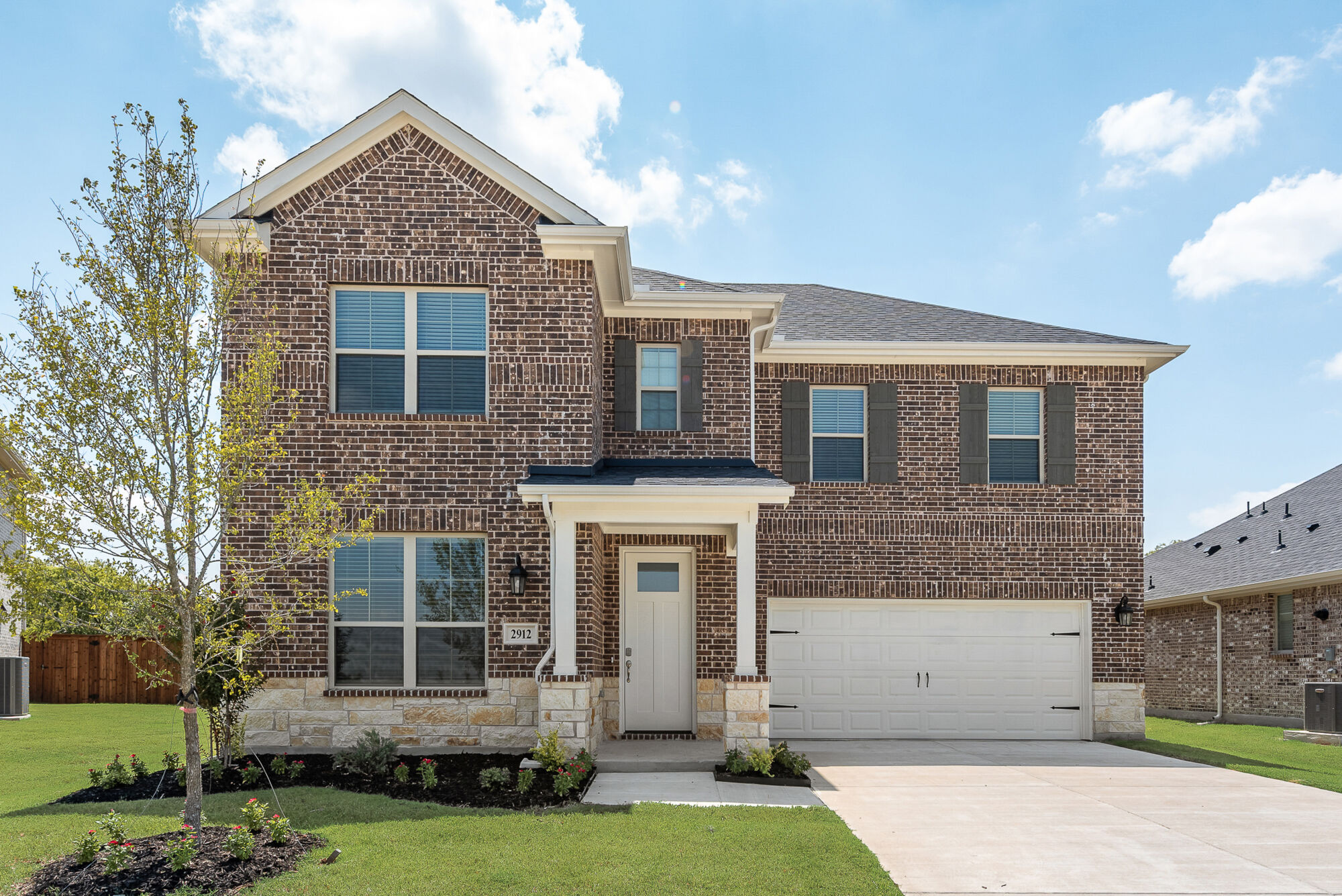 Elevation Front with window, garage and exterior brick