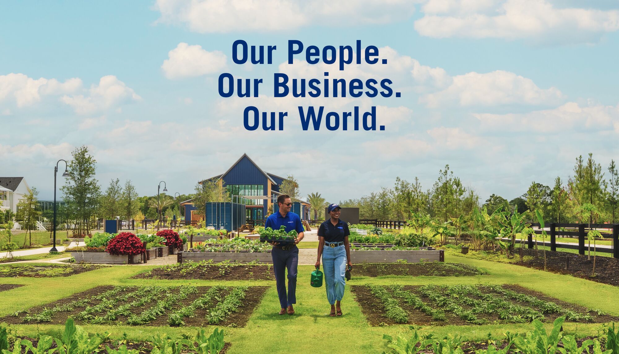 Two people walk through a community garden within a Mattamy community in Florida.