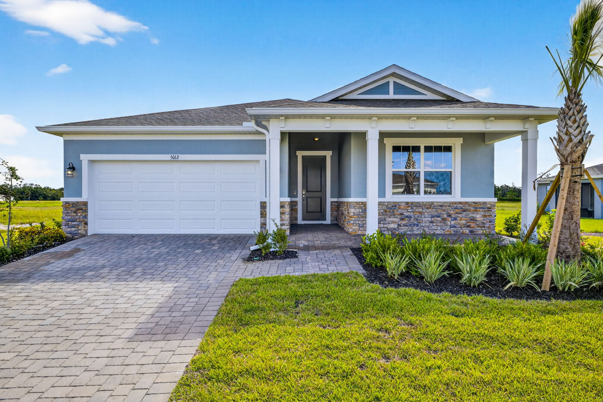  Elevation Front with garage, window, door and exterior stone