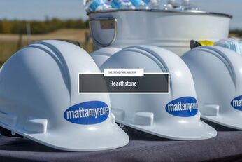 Row of white Mattamy Homes hard hats with subtext reading "Sherwood Park, Alberta" and title reading "Hearthstone"
