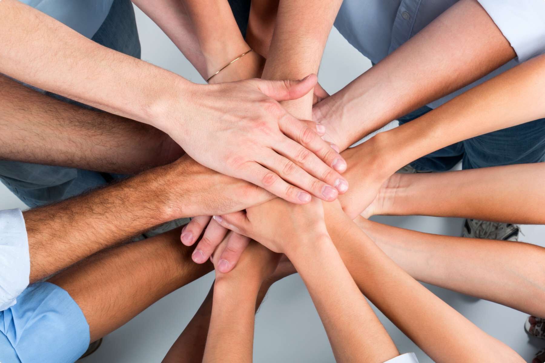 People with their hands in the middle.