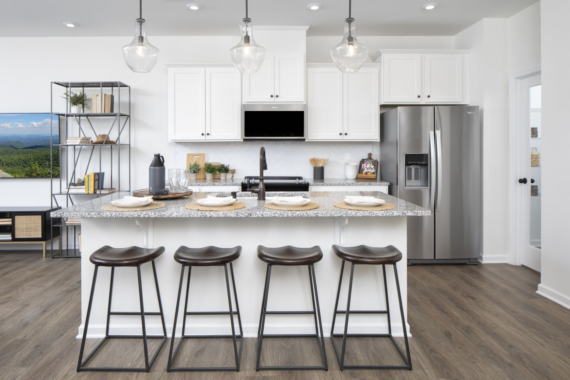 Single-Wall Kitchen with refrigerator, pendant light, white cabinets and wood flooring
