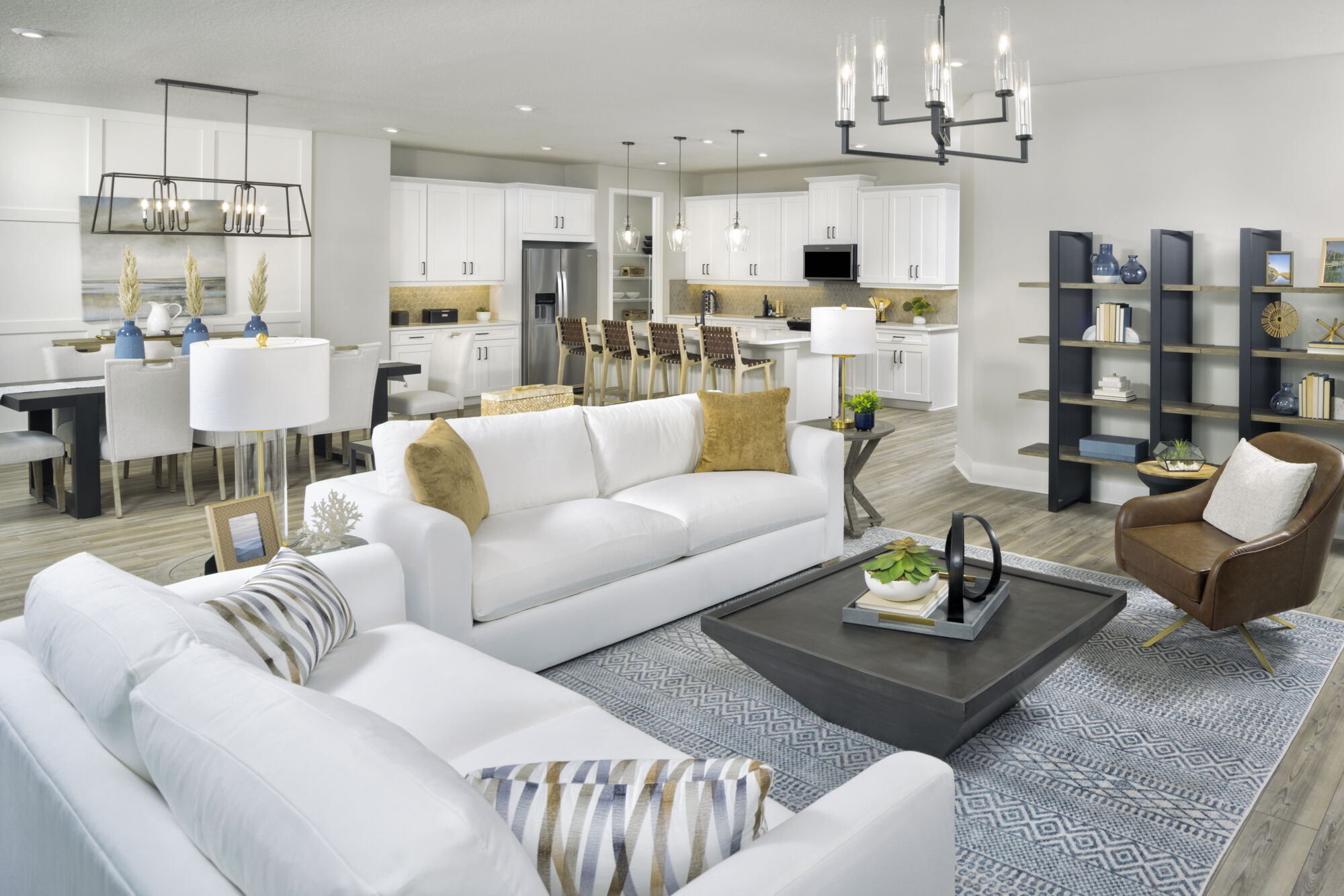  Greatroom with white cabinets, rug, refrigerator and pendant light