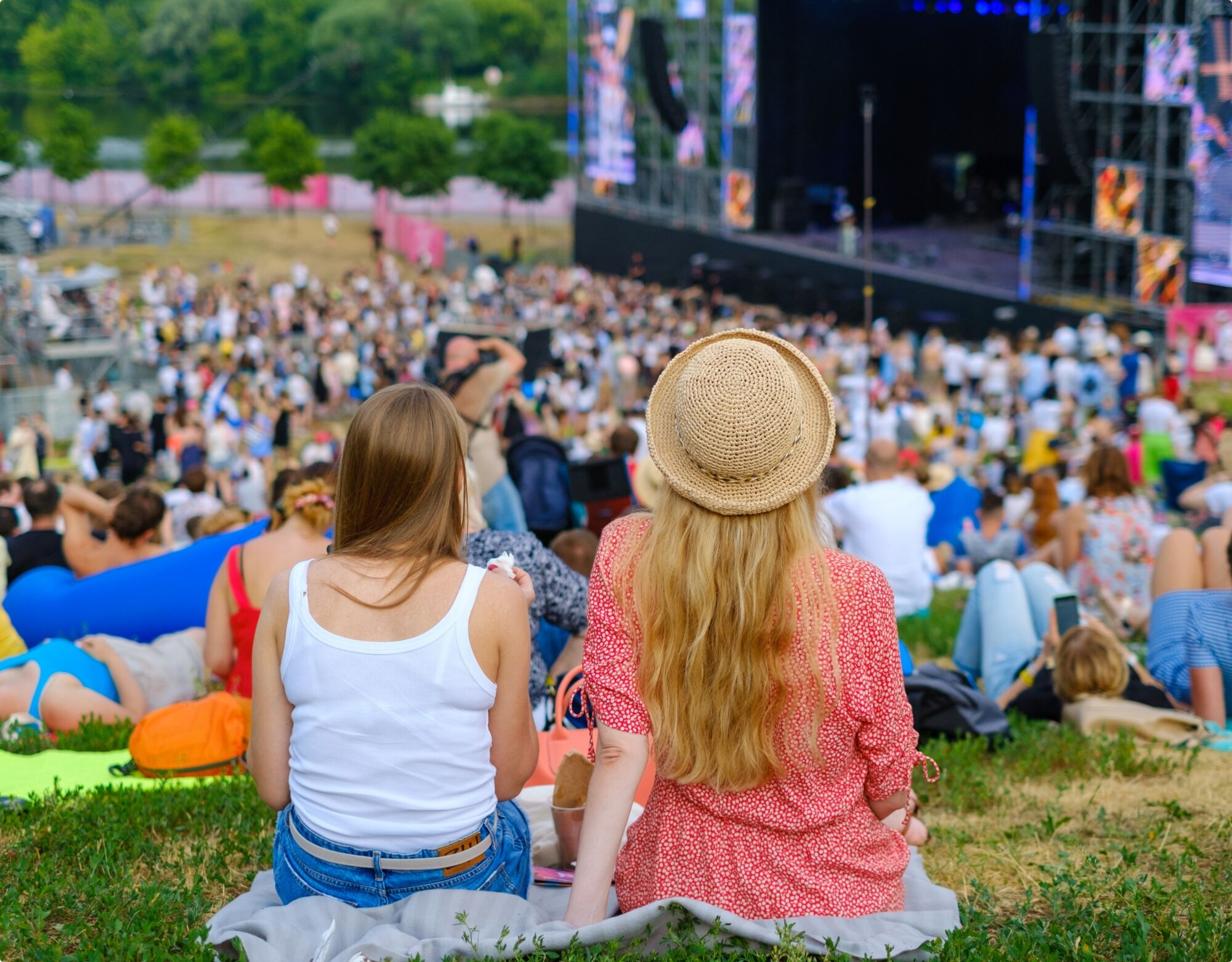 A crowd of people watching a concert outdoors