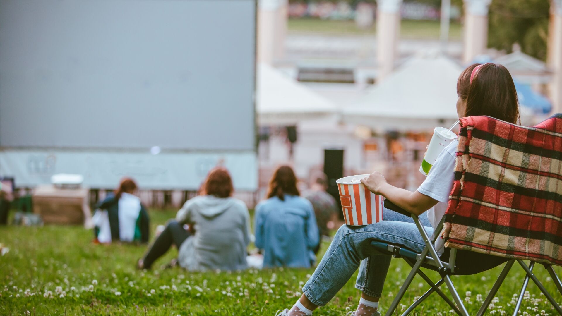A group of people watching a movie outdoors