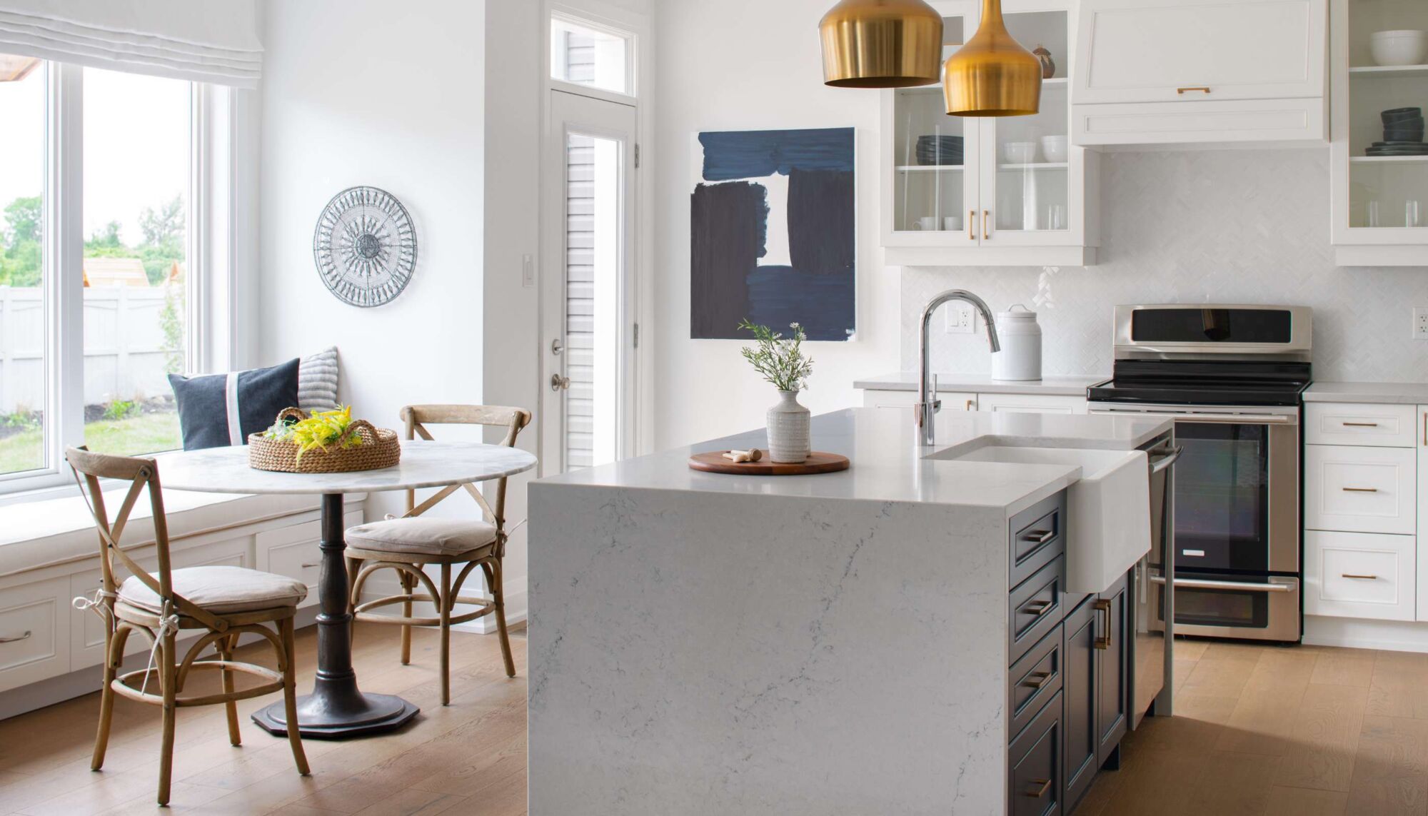 Single-wall kitchen with painting, wood flooring, pendant light, glassfront cabinets, white cabinets, round table