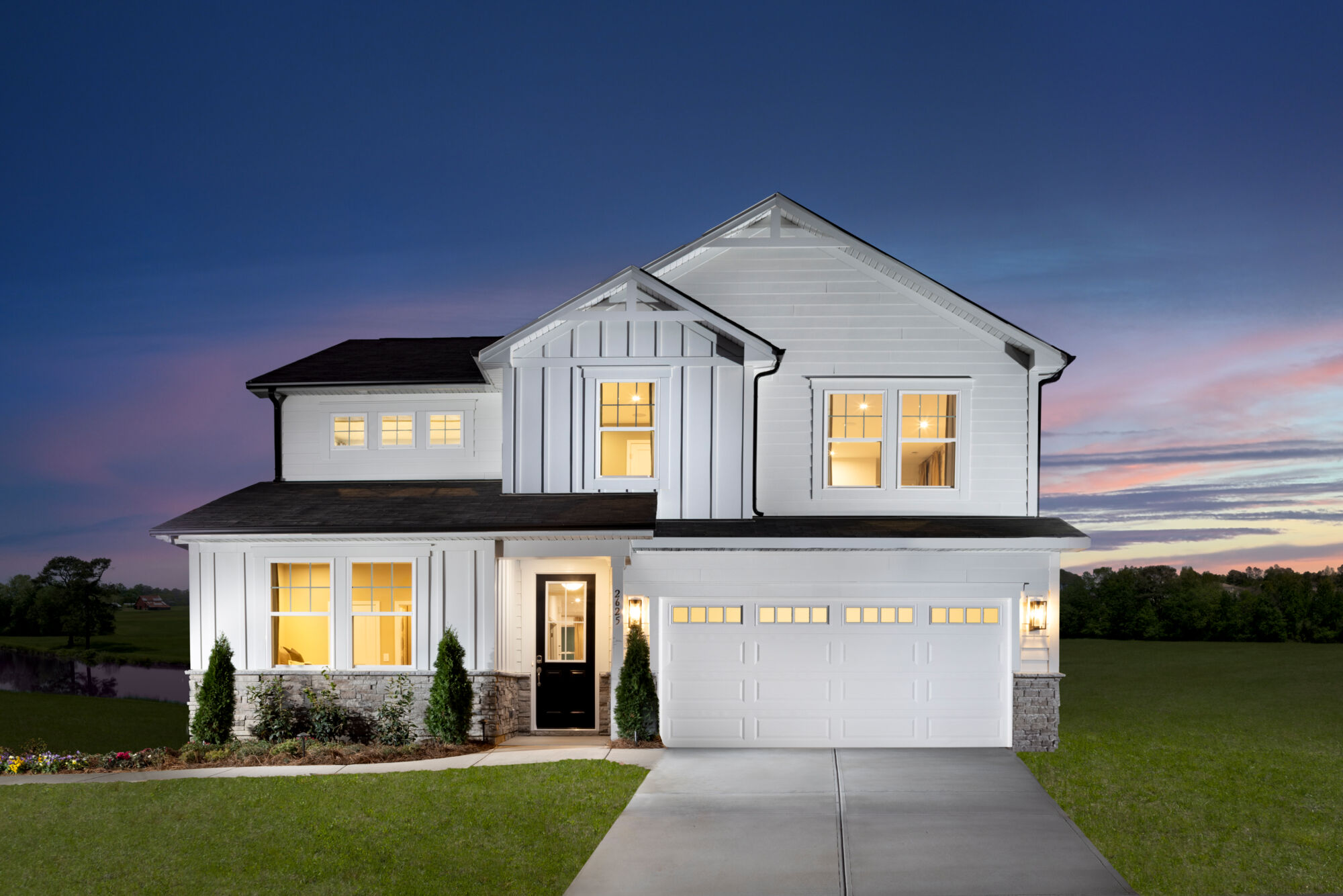  Elevation Front with window, garage, door, exterior stone and exterior clapboard