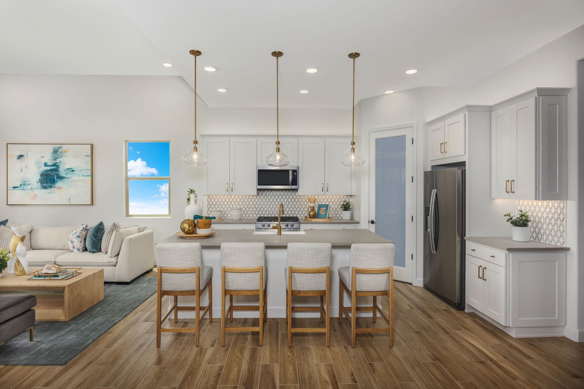 Kitchen with door, window, painting, refrigerator, white cabinets, pendant light, rug and wood flooring