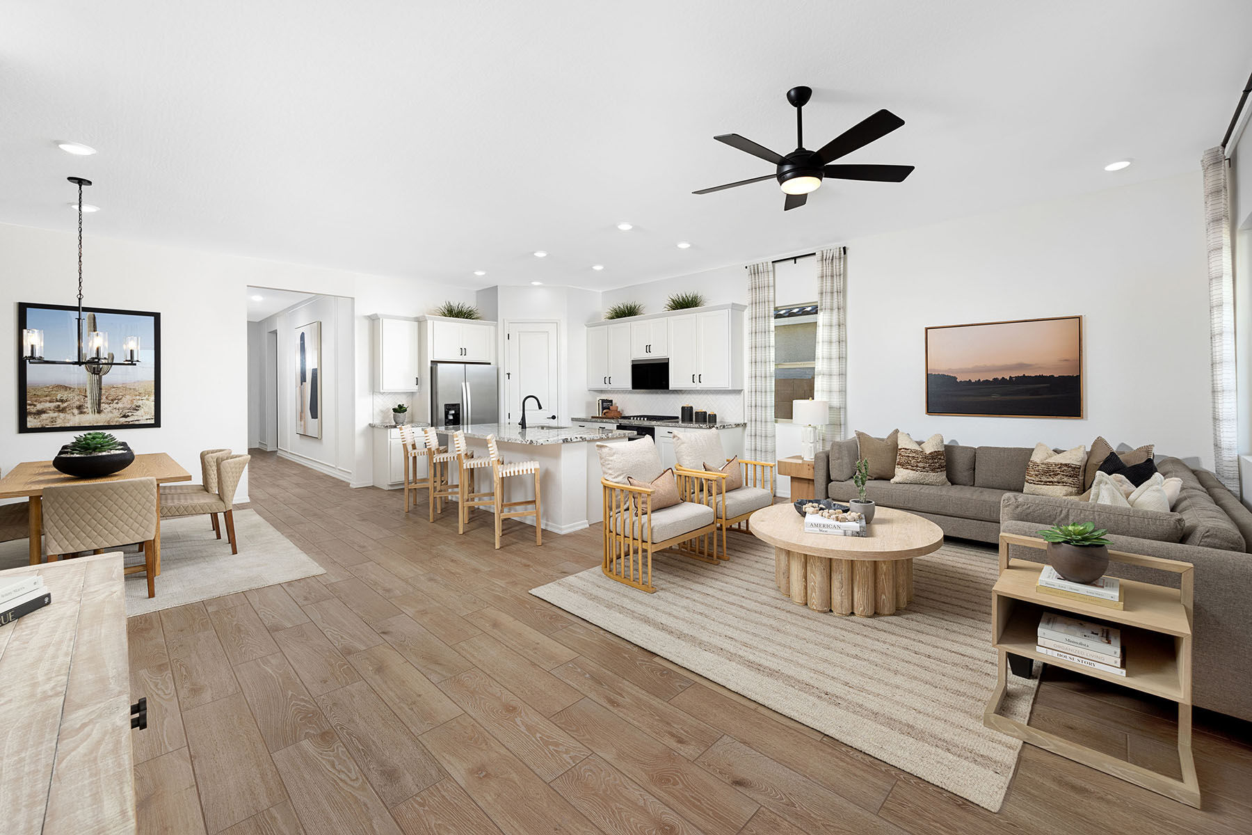  Greatroom with rug, curtains, painting, pendant light, refrigerator, door, window, white cabinets and wood flooring