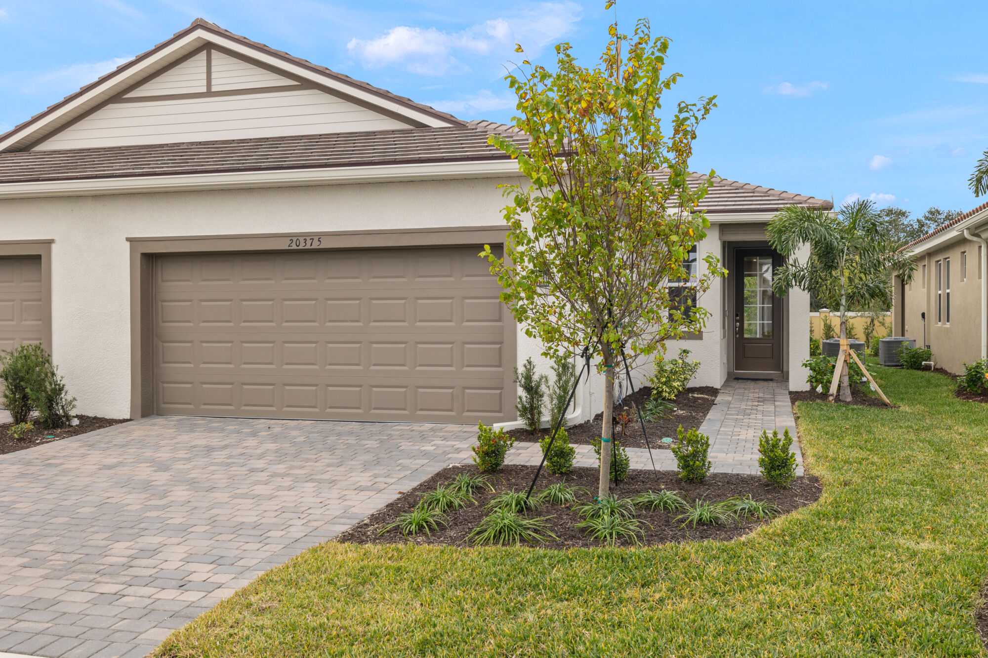 Oceana Villa, 2 bedroom, 2 bathroom, study, 2-car garage, open concept kitchen, dining and great room, glass sliders, covered lanai, plank tile flooring, quartz countertops, walk-in closet, glass enclosed owners shower, laundry room, shower/tub combo, shaker style cabinets, pantry, 