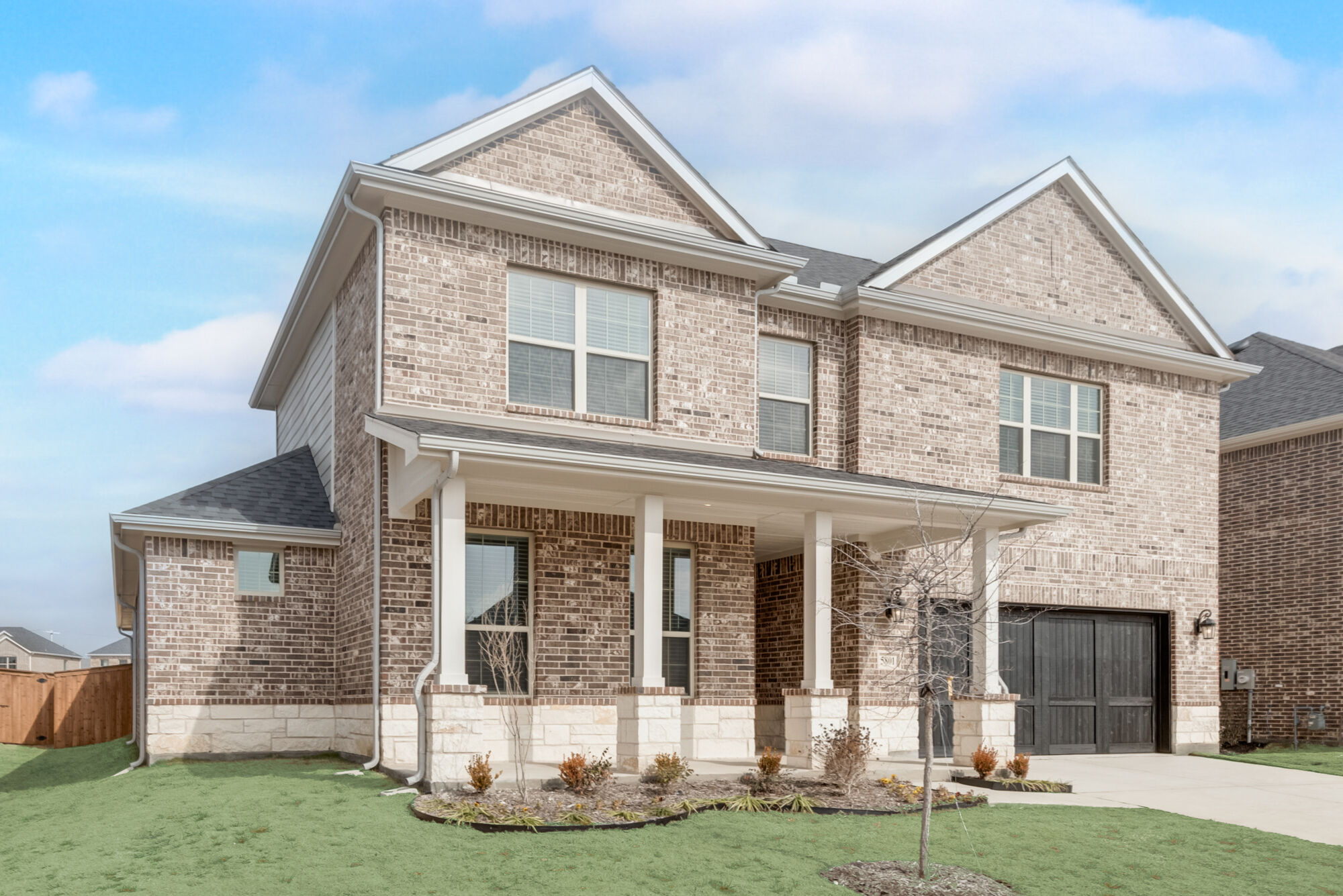 Elevation Front with window, garage and exterior brick