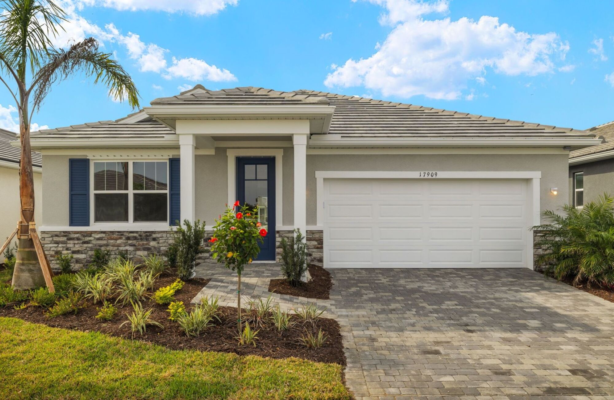 single family, 3 bedroom, study, 3 bathrooms, 2-car garage, 2 walk-in closets in Owner's Bedroom, dual sink vanity, open kitchen, dining and great room, oversized glass sliders, covered lanai, lush landscaping, light shaker cabinets, light quartz countertops, island, pantry, tan neutral flooring in tile and carpet