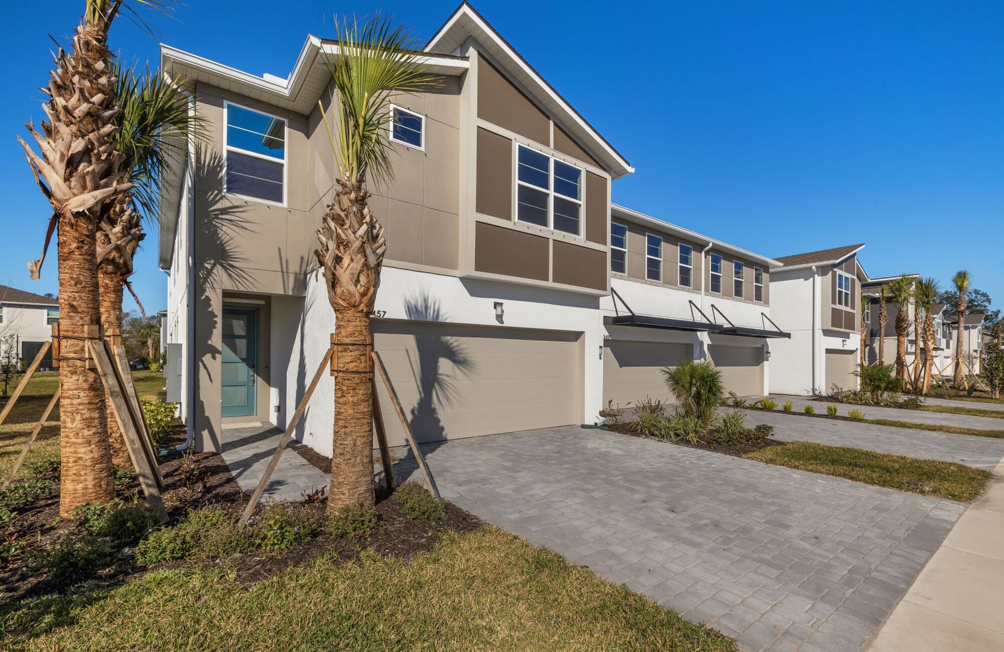 town home, end unit, palm trees, green door, paver driveway, 2-car garage, contemporary exterior, 